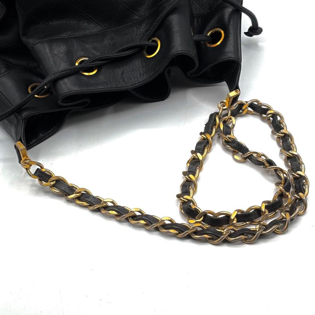 Vintage Chanel drawstring closure on black Bicolore leather bag
