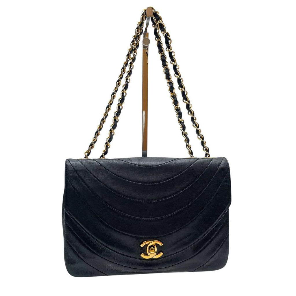 Chanel double gold chain shoulder straps on black lambskin flap bag