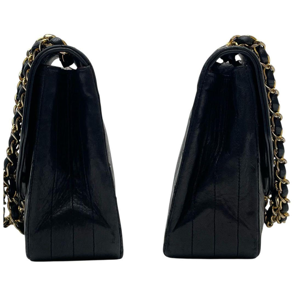 Side View Chanel double gold chain shoulder straps on black lambskin flap bag